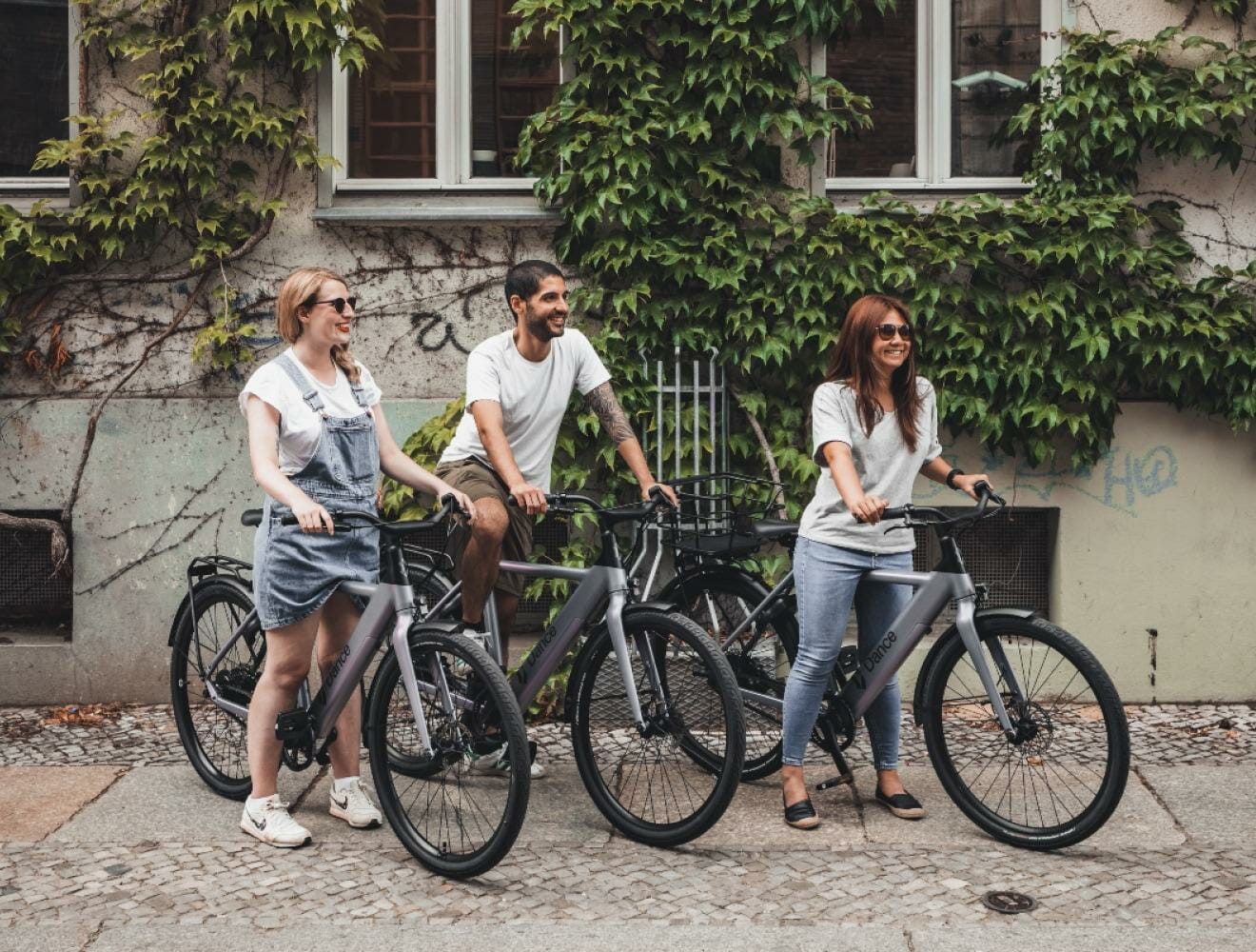 A group of citygoers on their ebikes in a city.